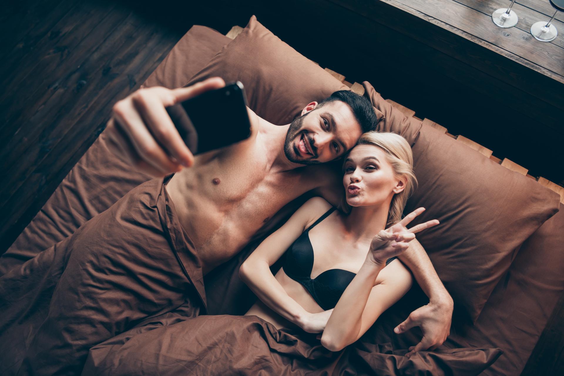 Swinger couple taking selfie for social media Swinger couple taking selfie for social media