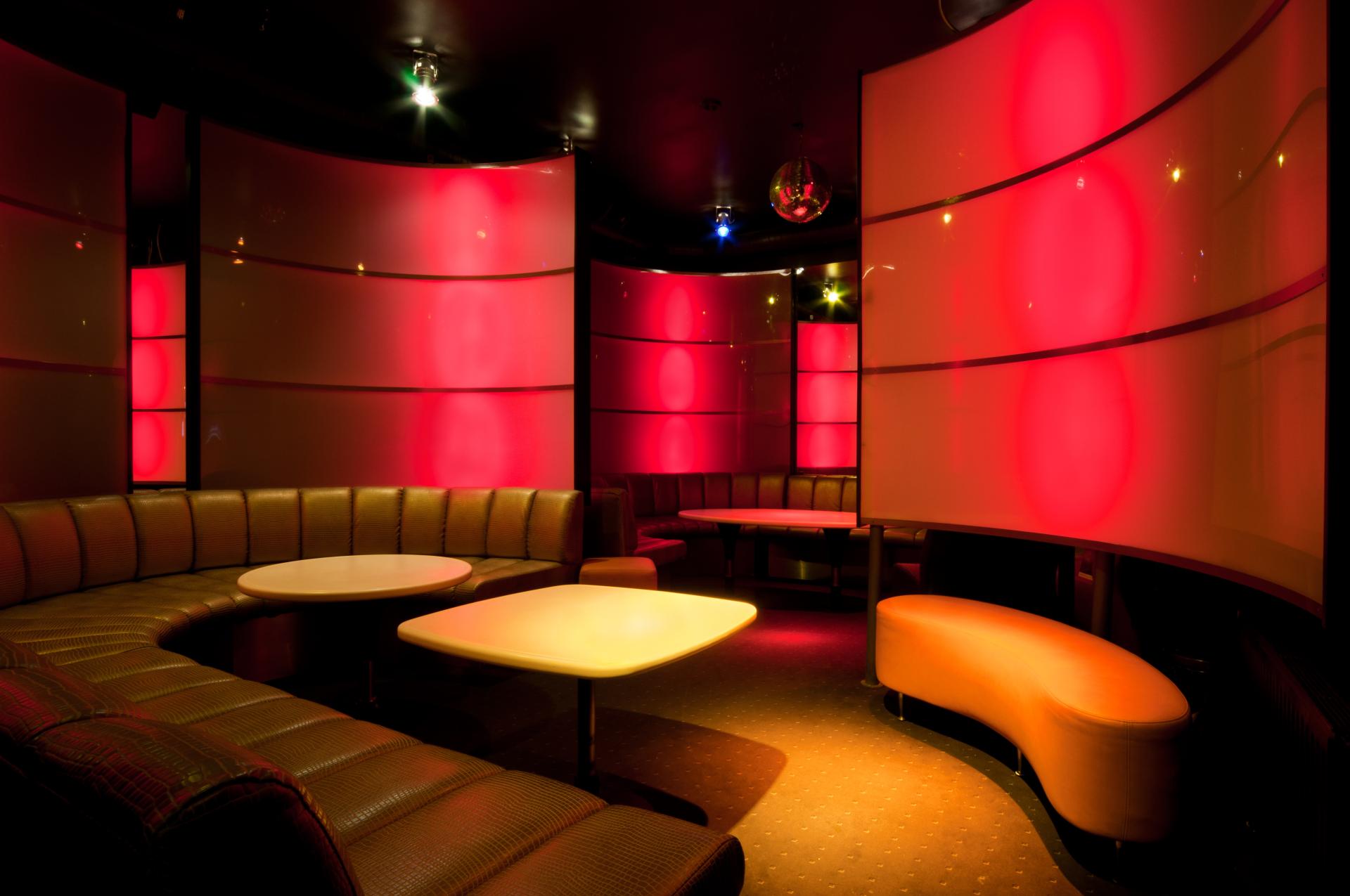 Red and gold themed nightclub with leather sofas and curved red room dividers Red and gold themed nightclub with leather sofas and curved red room dividers