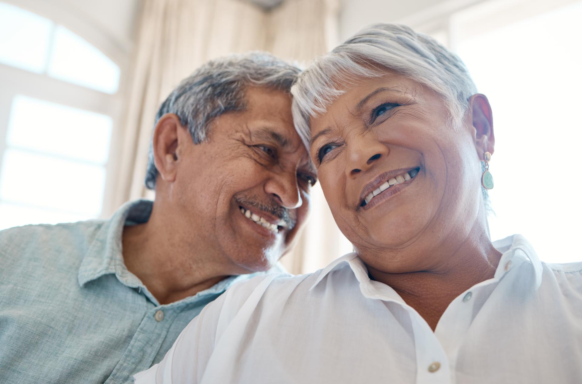 Closeup view of a happy mature couple having an intimate moment pressing their heads together Closeup view of a happy mature couple having an intimate moment pressing their heads together