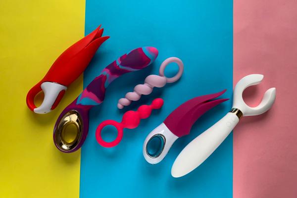 collection of colorful sex toys over a yellow, blue, and pink color-blocked background collection of colorful sex toys over a yellow, blue, and pink color-blocked background