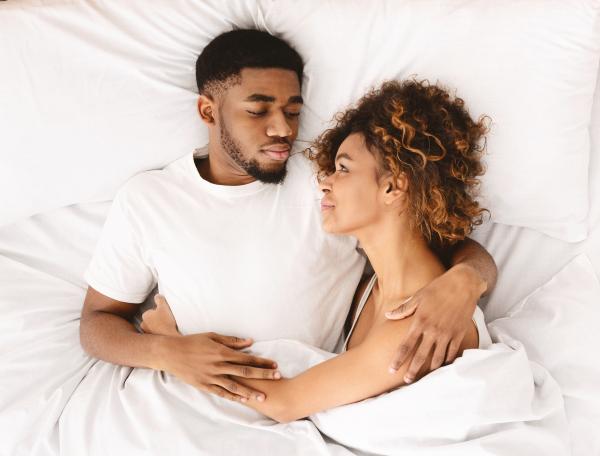 Swinger couple in bed working together to overcome erectile dysfunction Swinger couple in bed working together to overcome erectile dysfunction