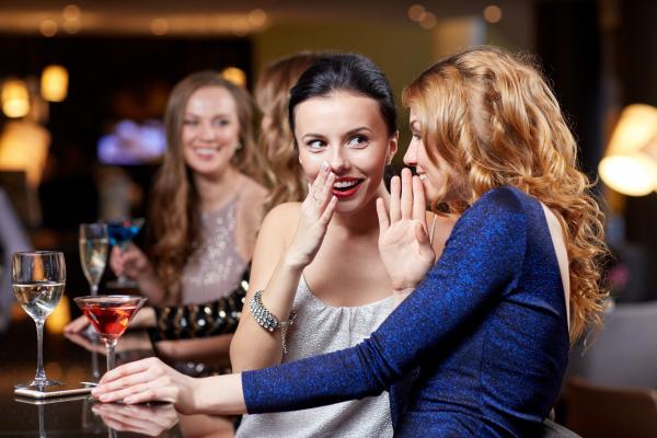 Two catty swinger women gossiping at the club Two catty swinger women gossiping at the club