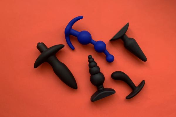 a photo of a collection of sex toys for men and other people with penises over a red background a photo of a collection of sex toys for men and other people with penises over a red background