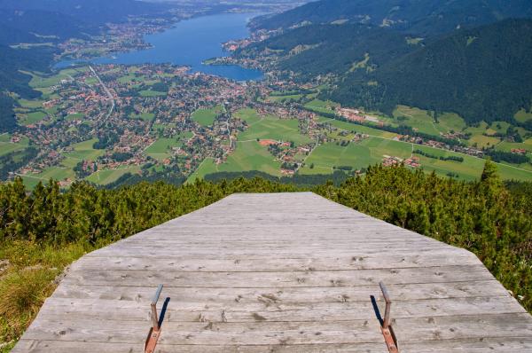 a photo of the edge of a paraglider ramp on a cliff overlooking a city a photo of the edge of a paraglider ramp on a cliff overlooking a city