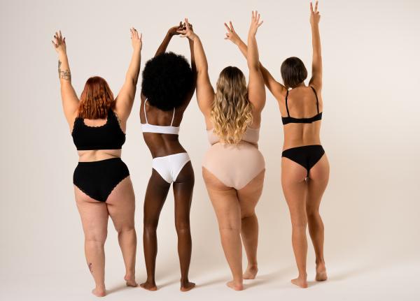 a photo of a group of diverse women in lingerie raising their hands in the air a photo of a group of diverse women in lingerie raising their hands in the air
