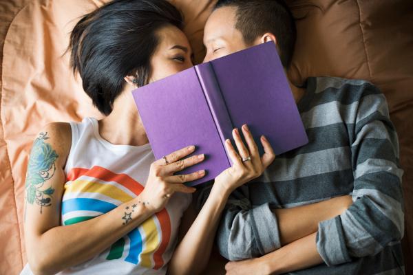 a photo of an intimate couple reading a book together a photo of an intimate couple reading a book together