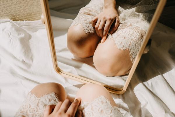 a photo of a woman in a white dress kneeling in front of a mirror a photo of a woman in a white dress kneeling in front of a mirror