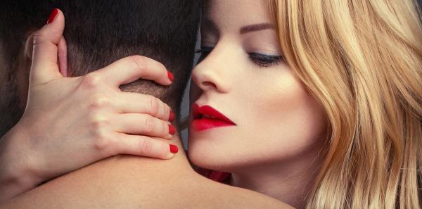 seductive blonde woman with red lips holding her hand behind a man's neck seductive blonde woman with red lips holding her hand behind a man's neck
