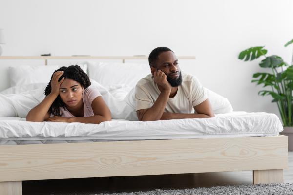 bored Black couple in bed bored Black couple in bed