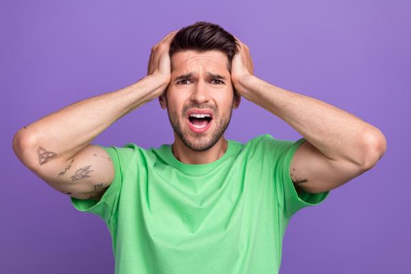 jealous man wearing a green shirt over a purple background jealous man wearing a green shirt over a purple background
