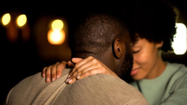 Black couple in love pressing foreheads together with her hands on his shoulders Black couple in love pressing foreheads together with her hands on his shoulders