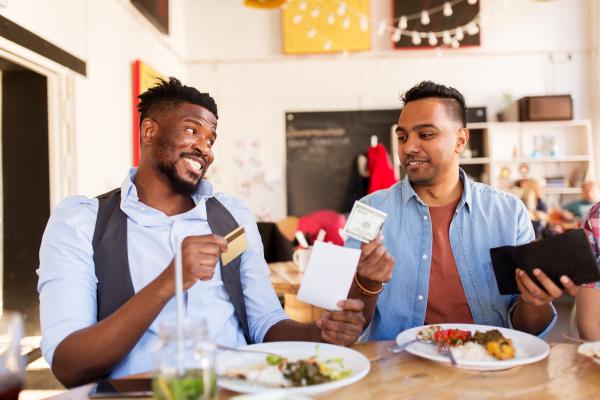 two men splitting the bill at a restaurant two men splitting the bill at a restaurant