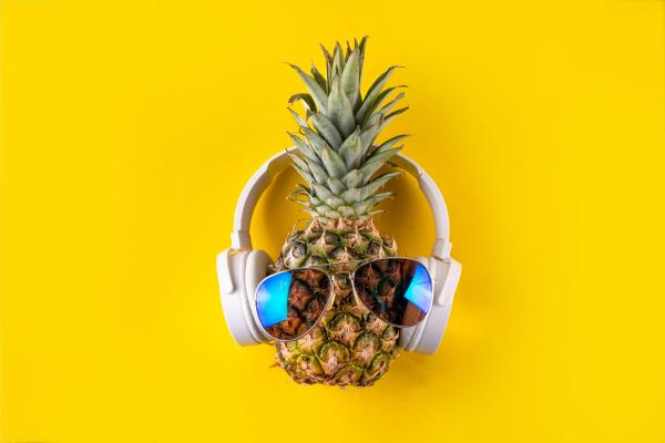 pineapple wearing sunglasses and headphones over a yellow background pineapple wearing sunglasses and headphones over a yellow background