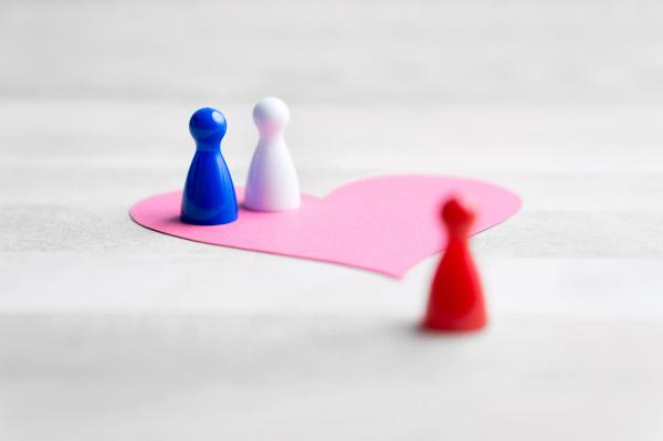 open relationship dynamics concept with two figures inside a paper heart and one outside of it open relationship dynamics concept with two figures inside a paper heart and one outside of it