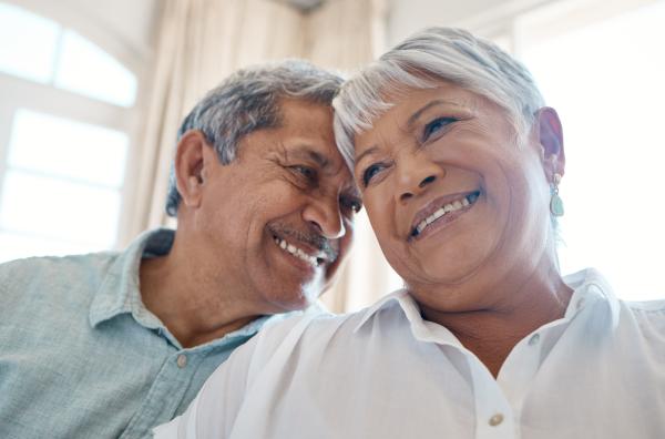 Closeup view of a happy mature couple having an intimate moment pressing their heads together Closeup view of a happy mature couple having an intimate moment pressing their heads together