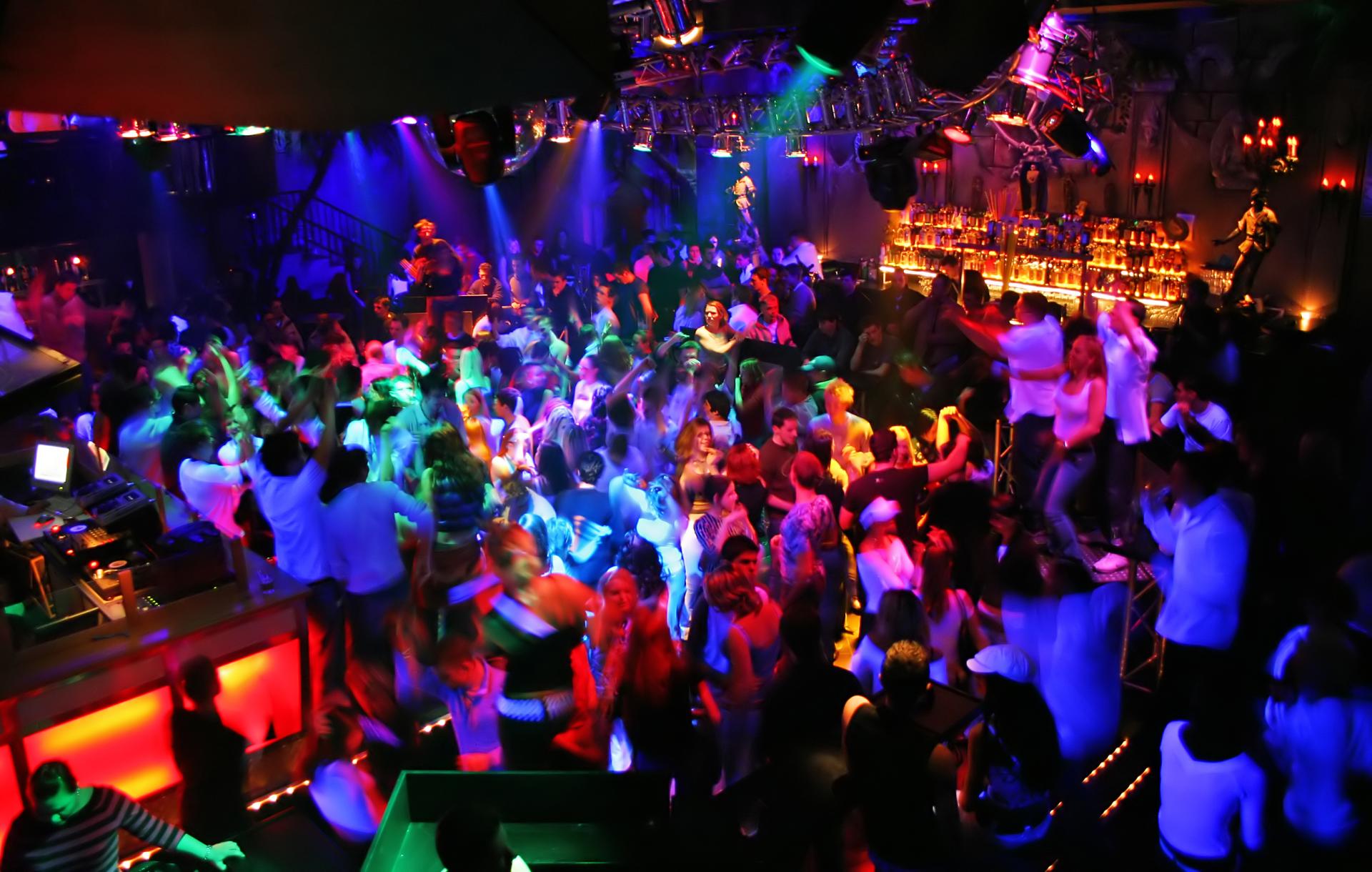 a photo of colorful nightclub Kandi party scene filled with dancing swingers