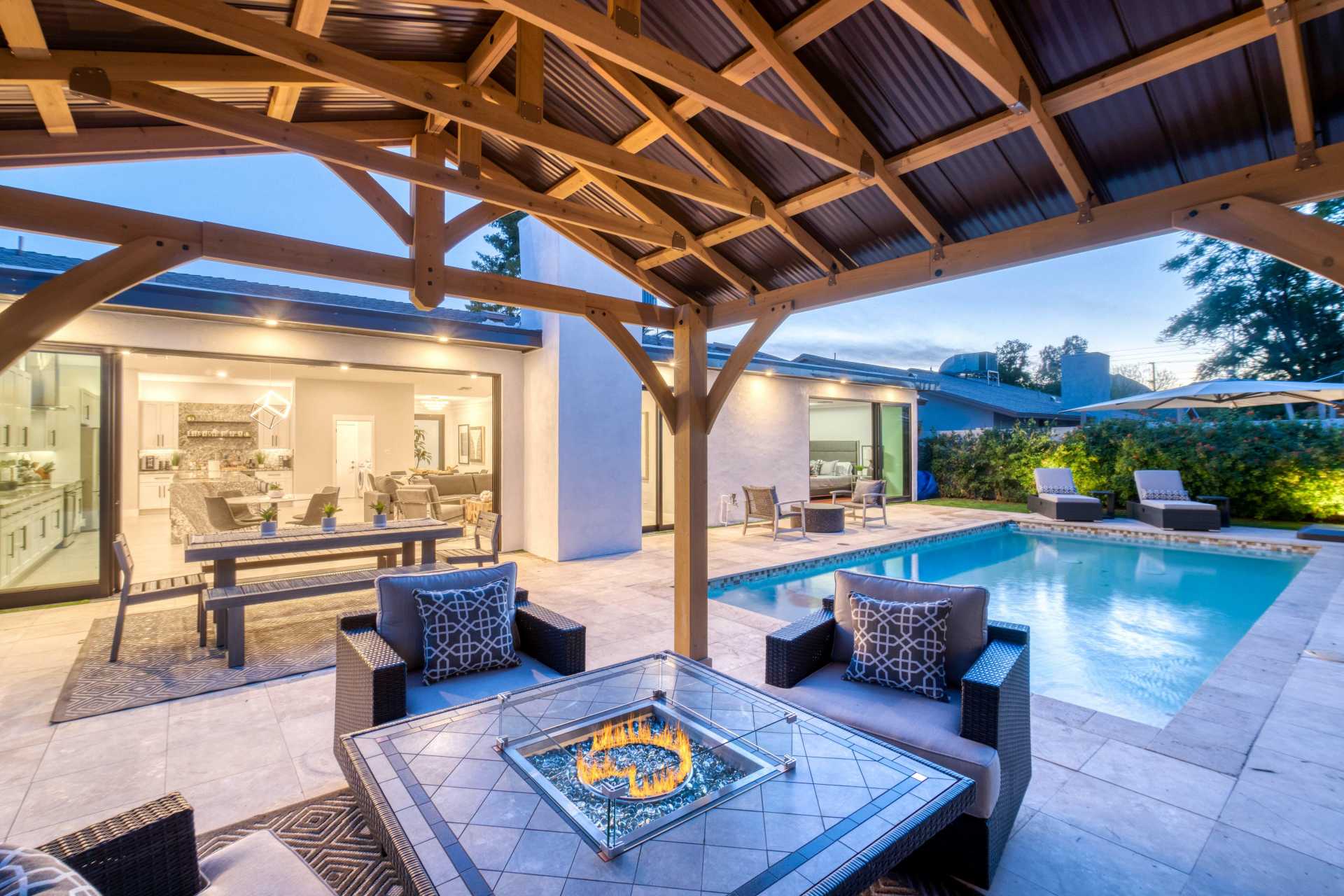 luxurious patio vacation scene with outdoor dining table and pool