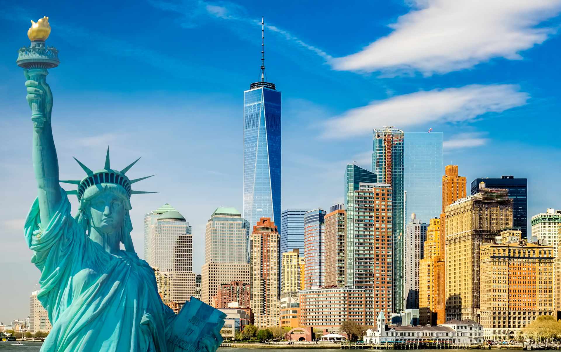 Lady Liberty Statue in the foreground in front of the New York City skyline