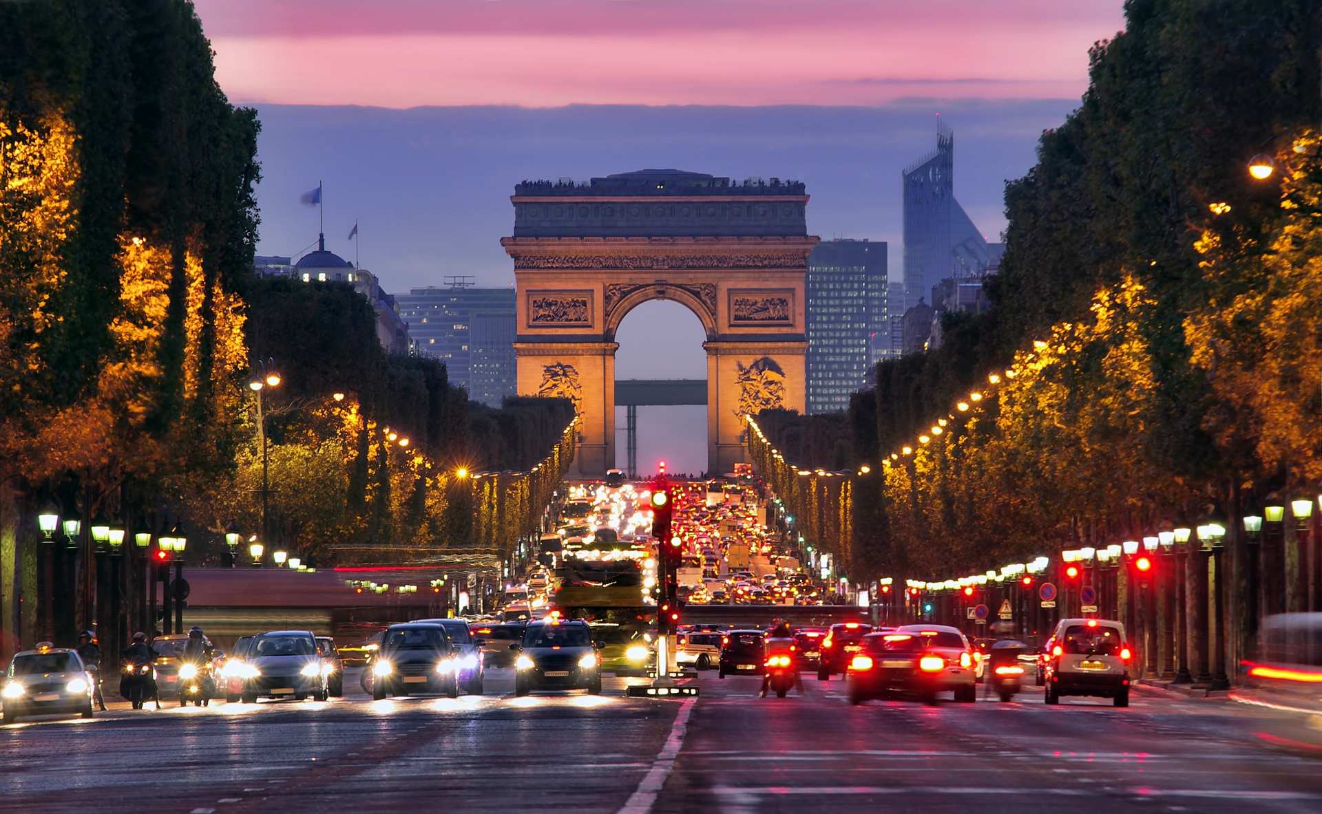 Champs Elysees and Arc de Triomphe in Paris France night scene with car traffic