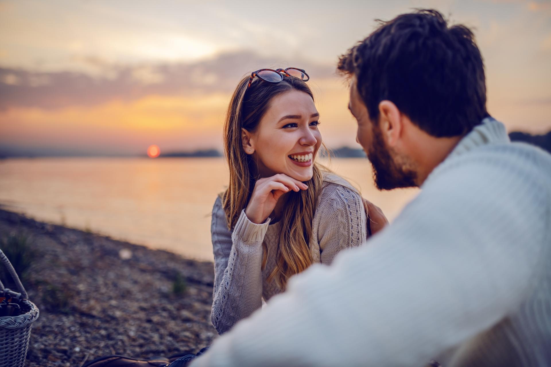 smiling woman with a man on the beach