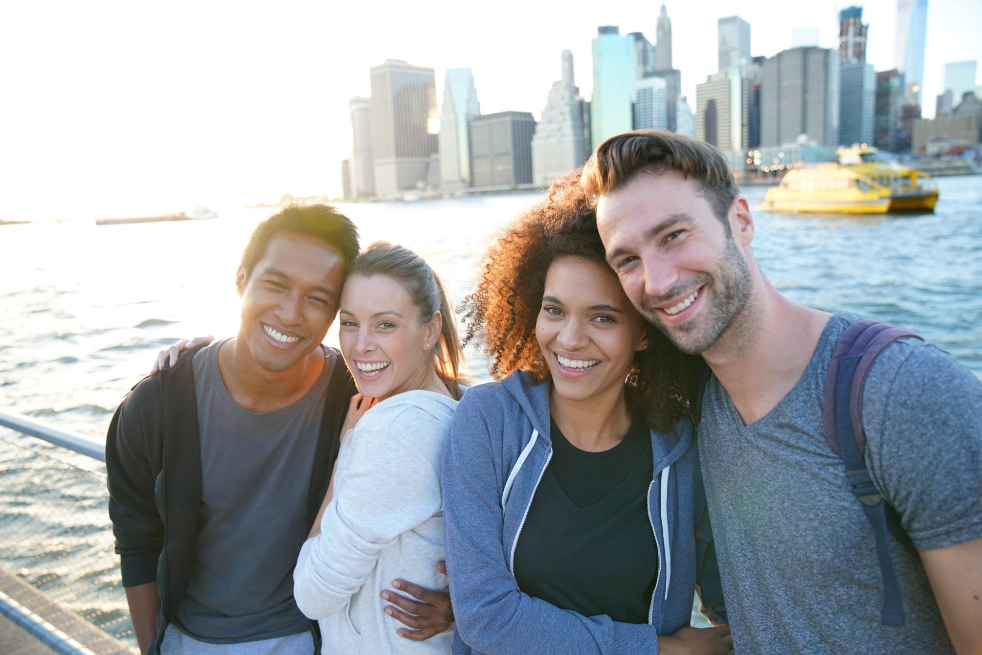 two couples taking a sunset selfie on Brooklyn Heights Promenade New York City