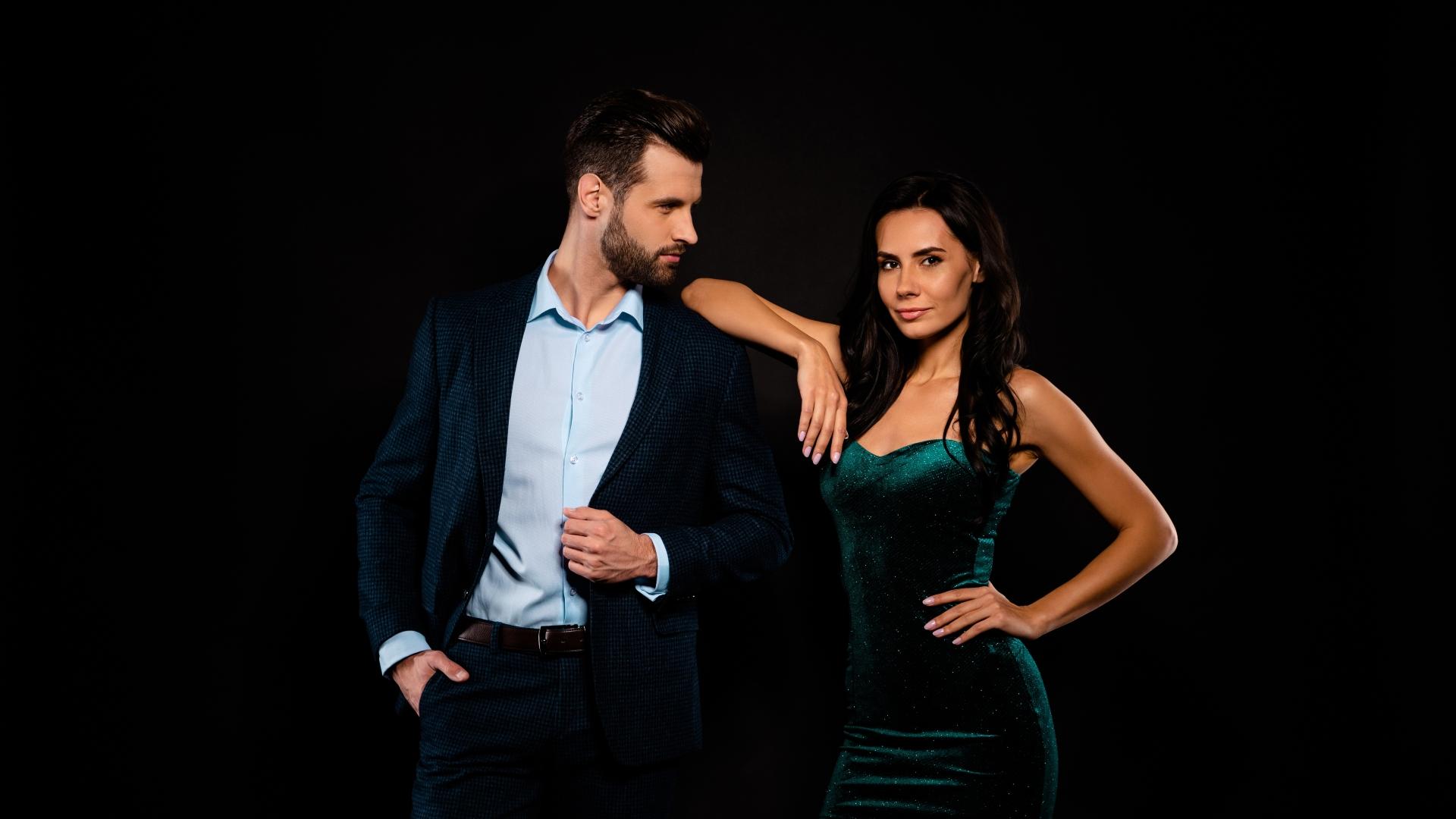 couple in party clothes over a black background