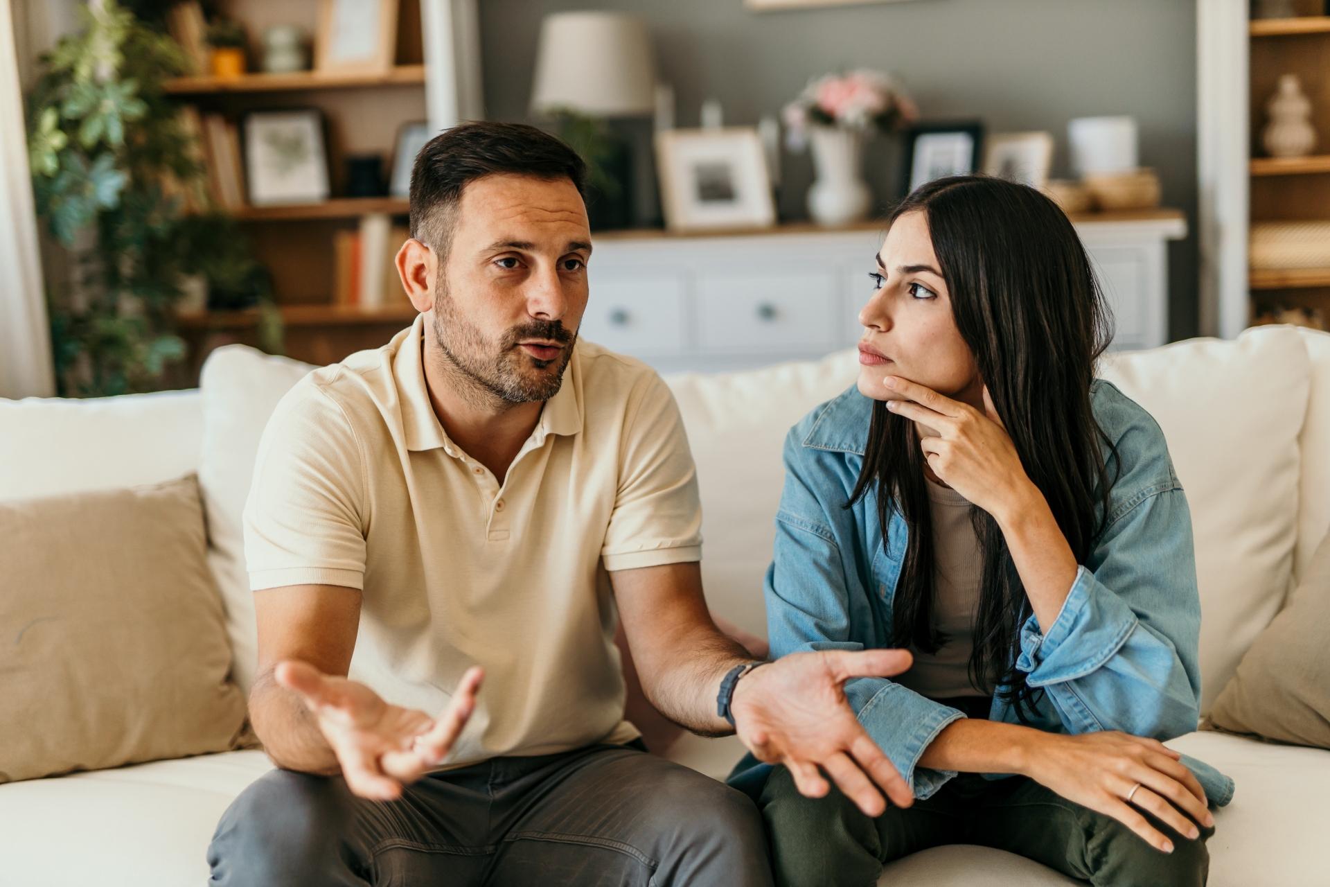 couple having a conversation on the couch