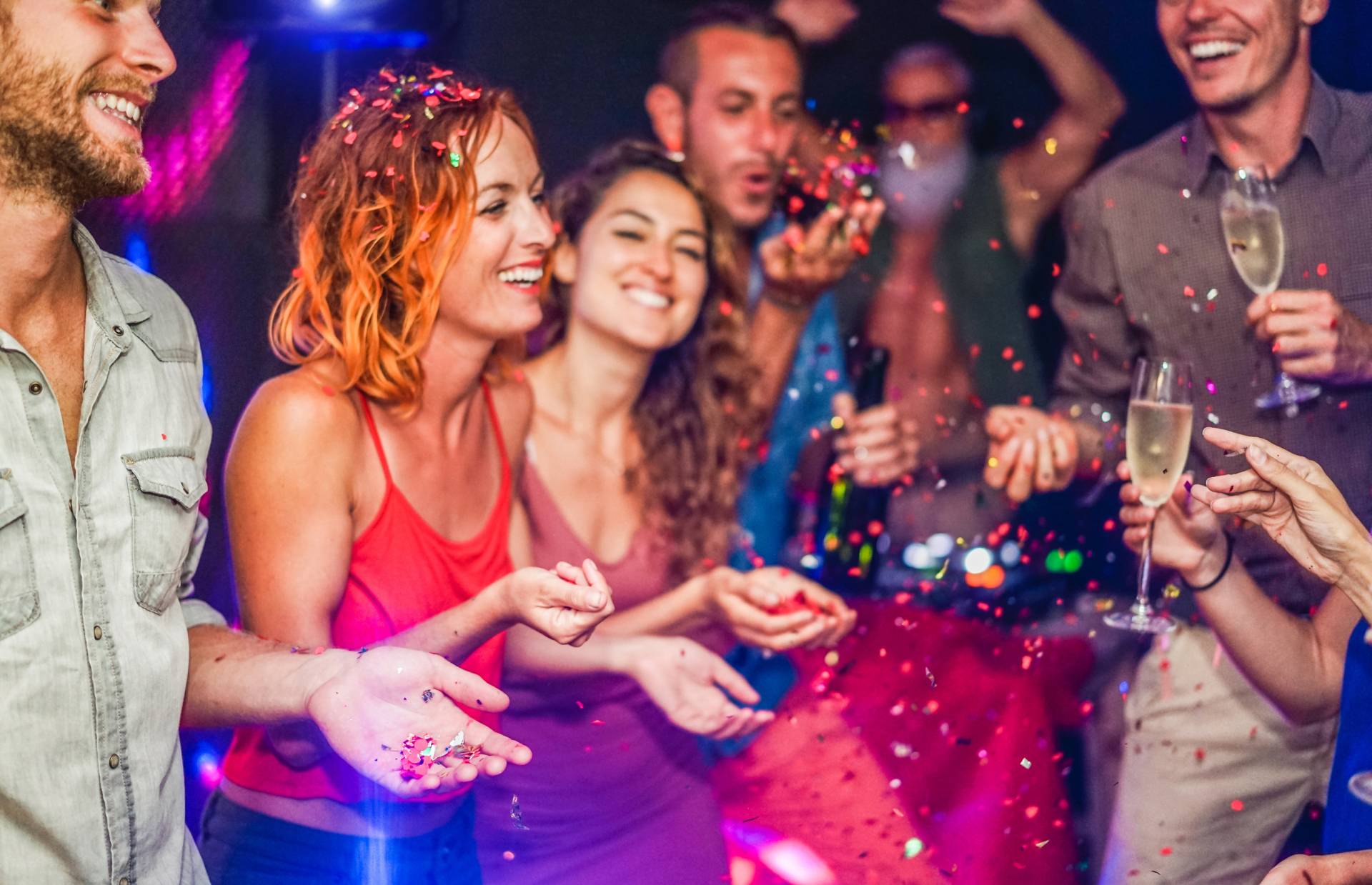 a group of people having drinks and partying at a club