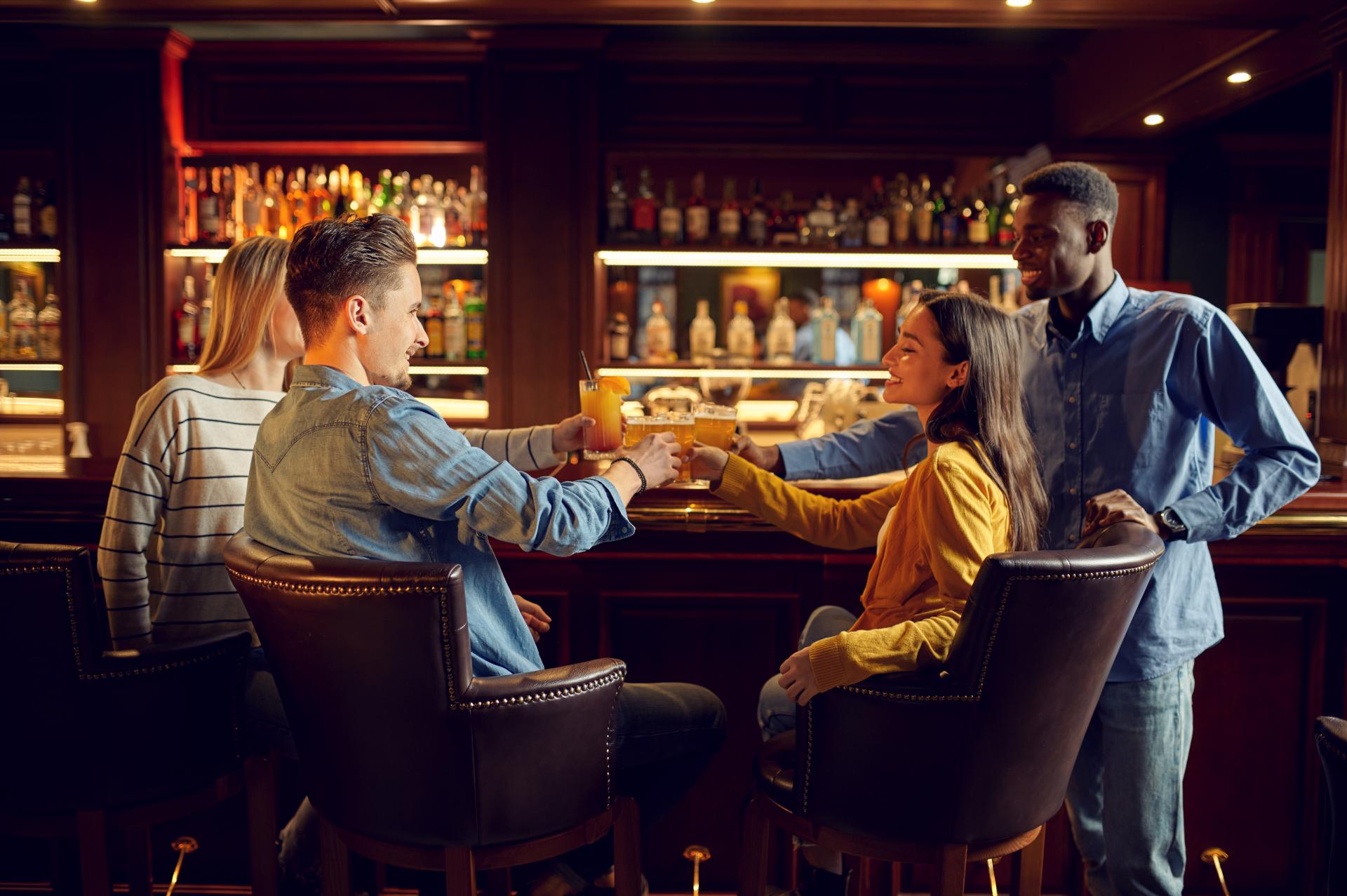 two couples celebrating with drinks at a club