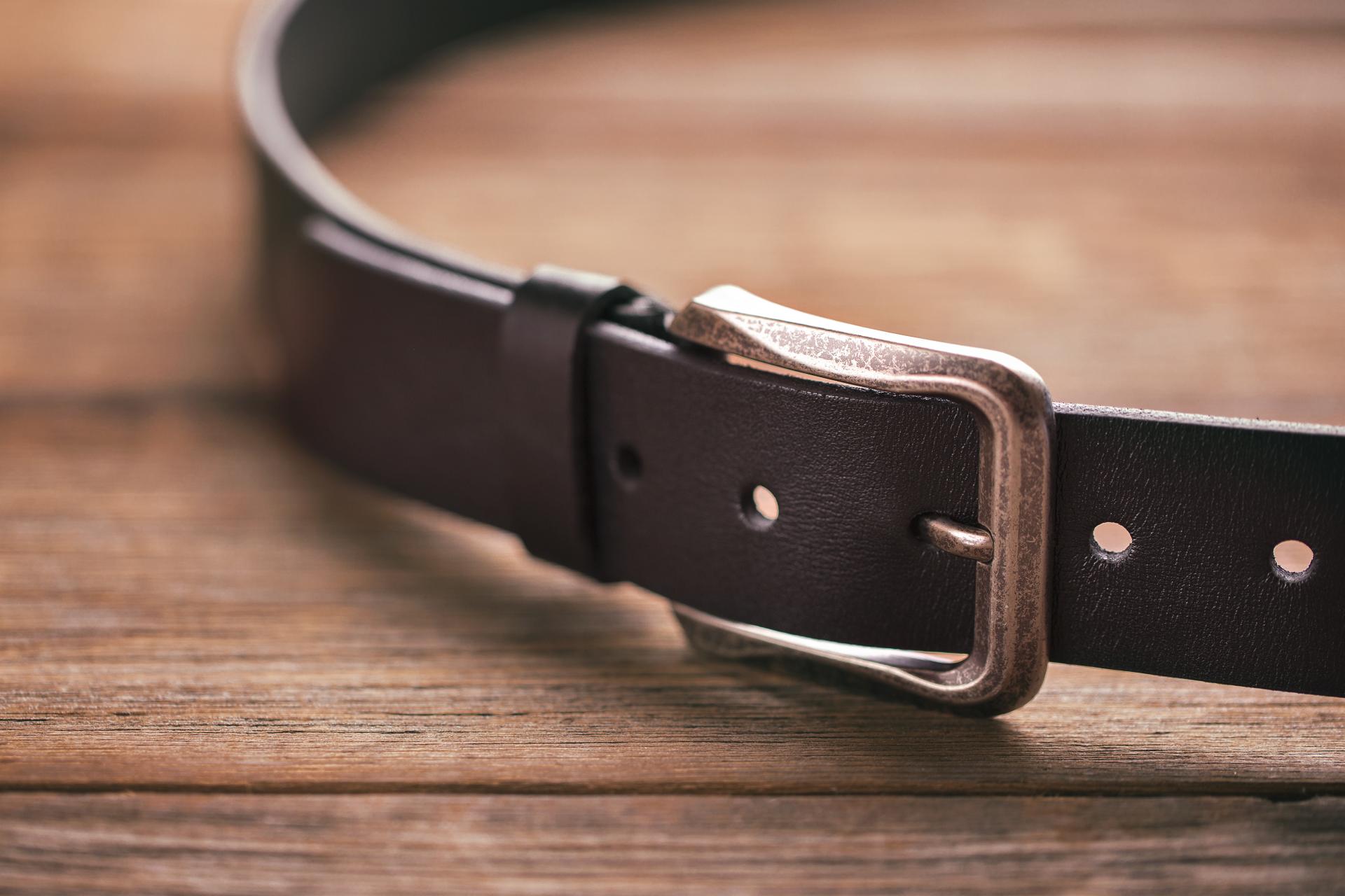 a black leather belt with a silver buckle