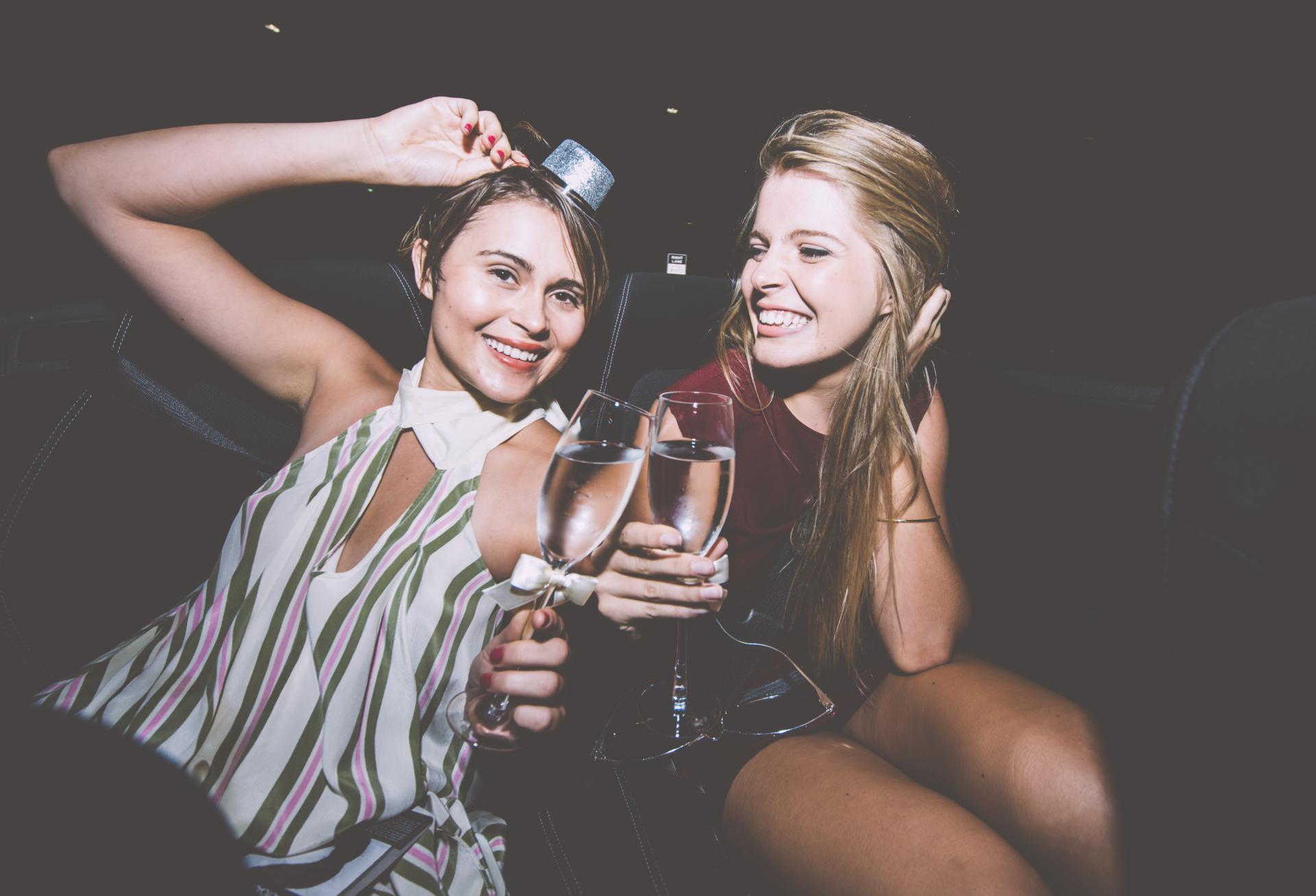 two women in a club holding champagne glasses