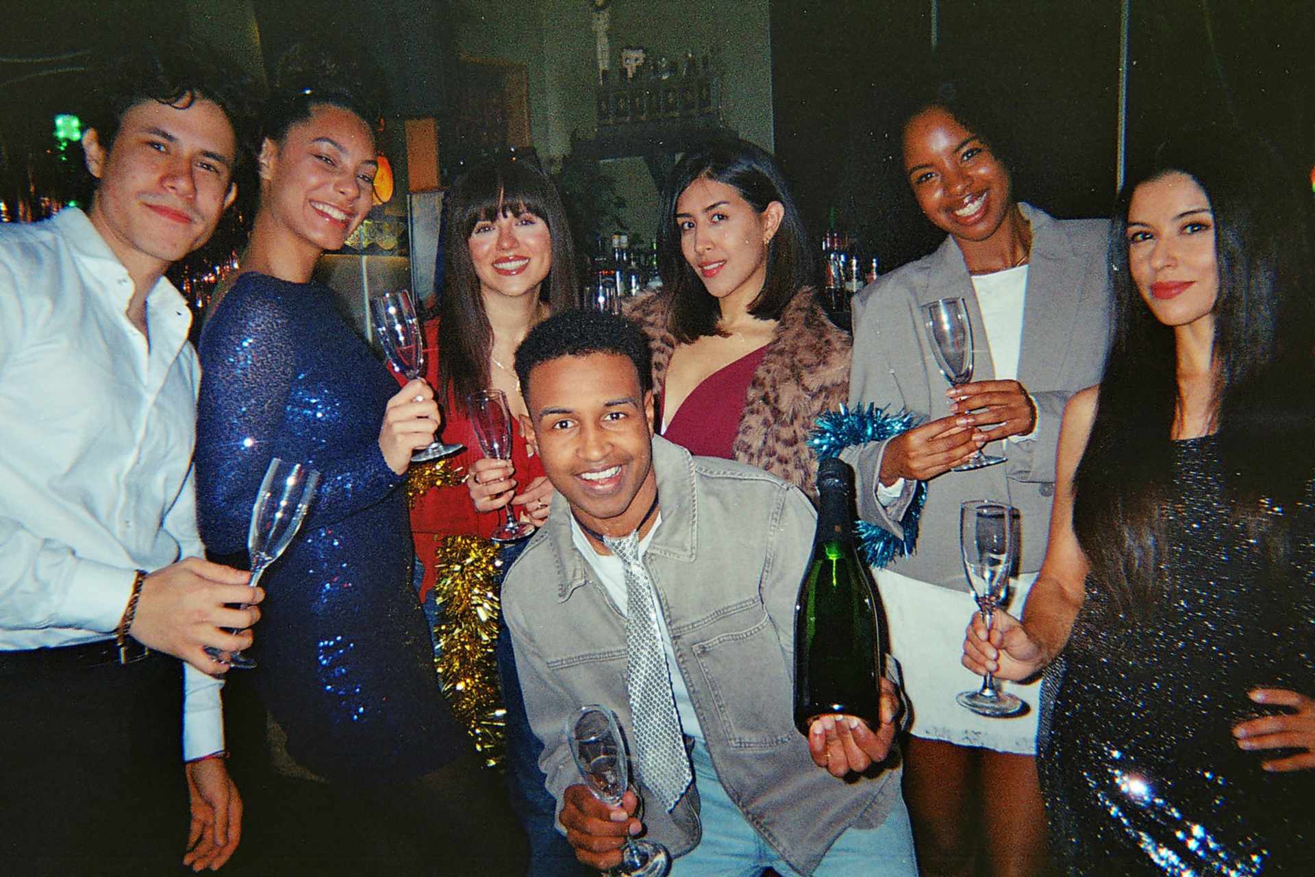a group of friends holding drinks and having fun at an event