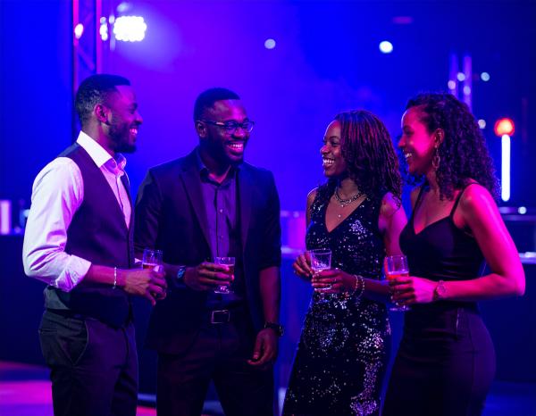 two couples talking in a dance club two couples talking in a dance club