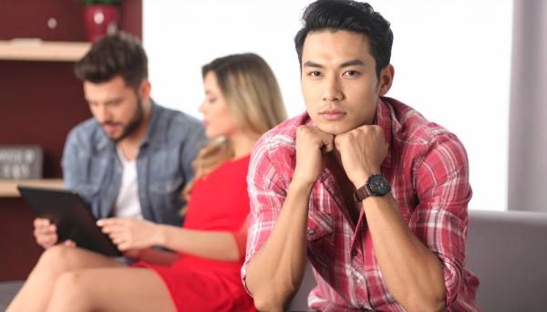 jealous man in front of a blurred couple