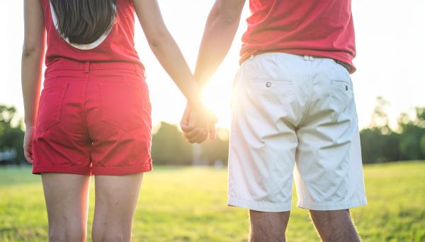 couple holding hands wearing casual sports fan colors