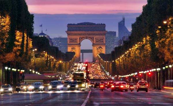 Champs Elysees and Arc de Triomphe in Paris France night scene with car traffic