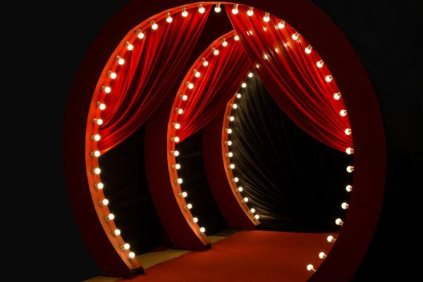circular red curtain path with light bulbs