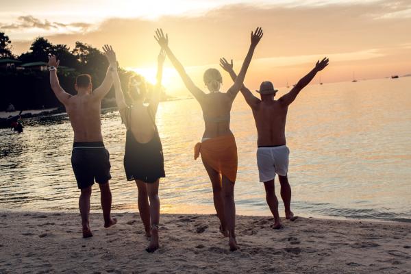 two couples having fun on the beach