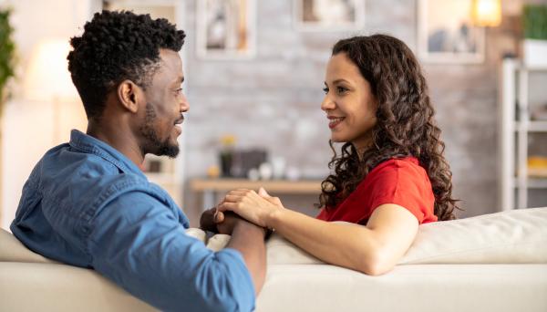 couple on a couch facing each other having a conversation
