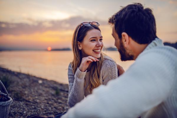 smiling woman with a man on the beach