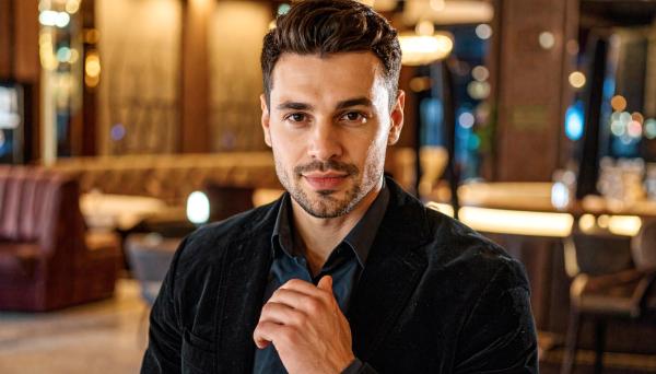 man in a dark velvet blazer at an upscale lounge