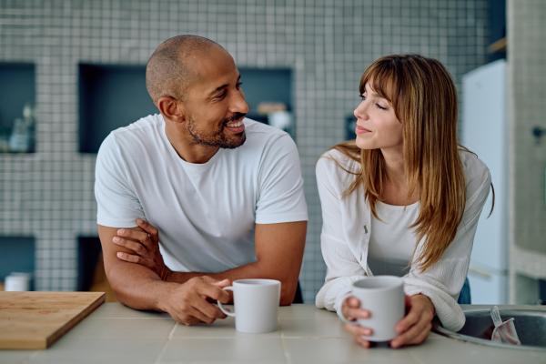 couple having hot beverages in the kitchen