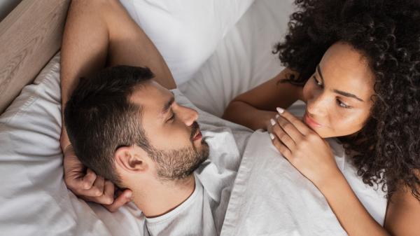 peaceful couple engaged in a tender moment in bed