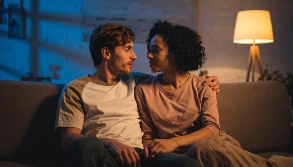 couple on the couch in a dimly lit room at night