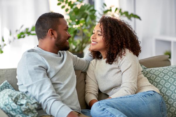 Couple sitting on a couch talking