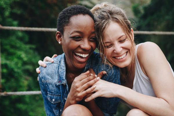 Two women laughing outdoors