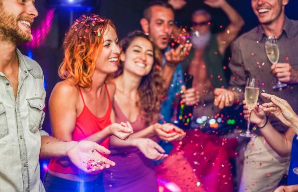 a group of people having drinks and partying at a club