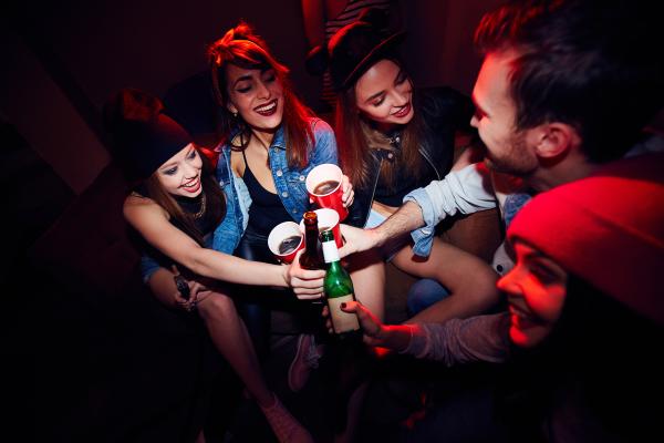 a group of people at a party toasting their drinks