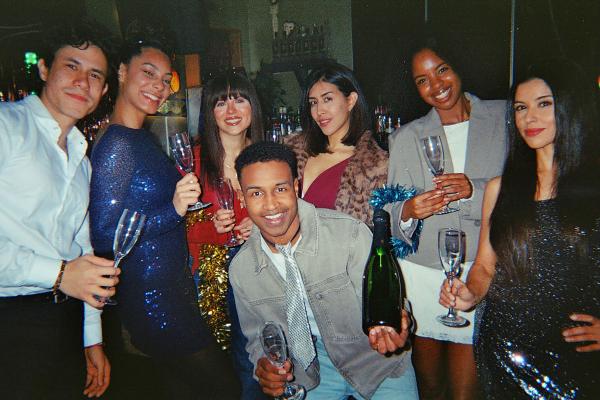 a group of friends holding drinks and having fun at an event