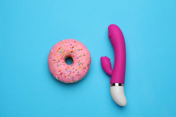 a pink donut and a purple vibrator against a blue background